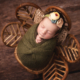 Baby girl in a rattan flower chair