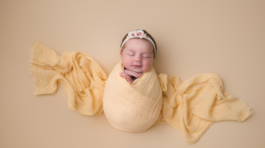 Newborn baby girl in yellow